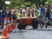 The Ware family weave through traffic cones Saturday as they race in the Camas Days bathtub races in downtown Camas.