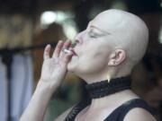 Pamela Luminaire smokes a joint Saturday at Mint Tea on Main Street, where patrons can smoke marijuana in designated areas, in Vancouver.