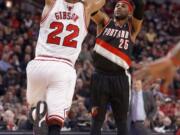 Portland Trail Blazers guard Mo Williams (25) shoots as Chicago Bulls forward Taj Gibson (22) defends during a game on March 28, 2014, in Chicago.