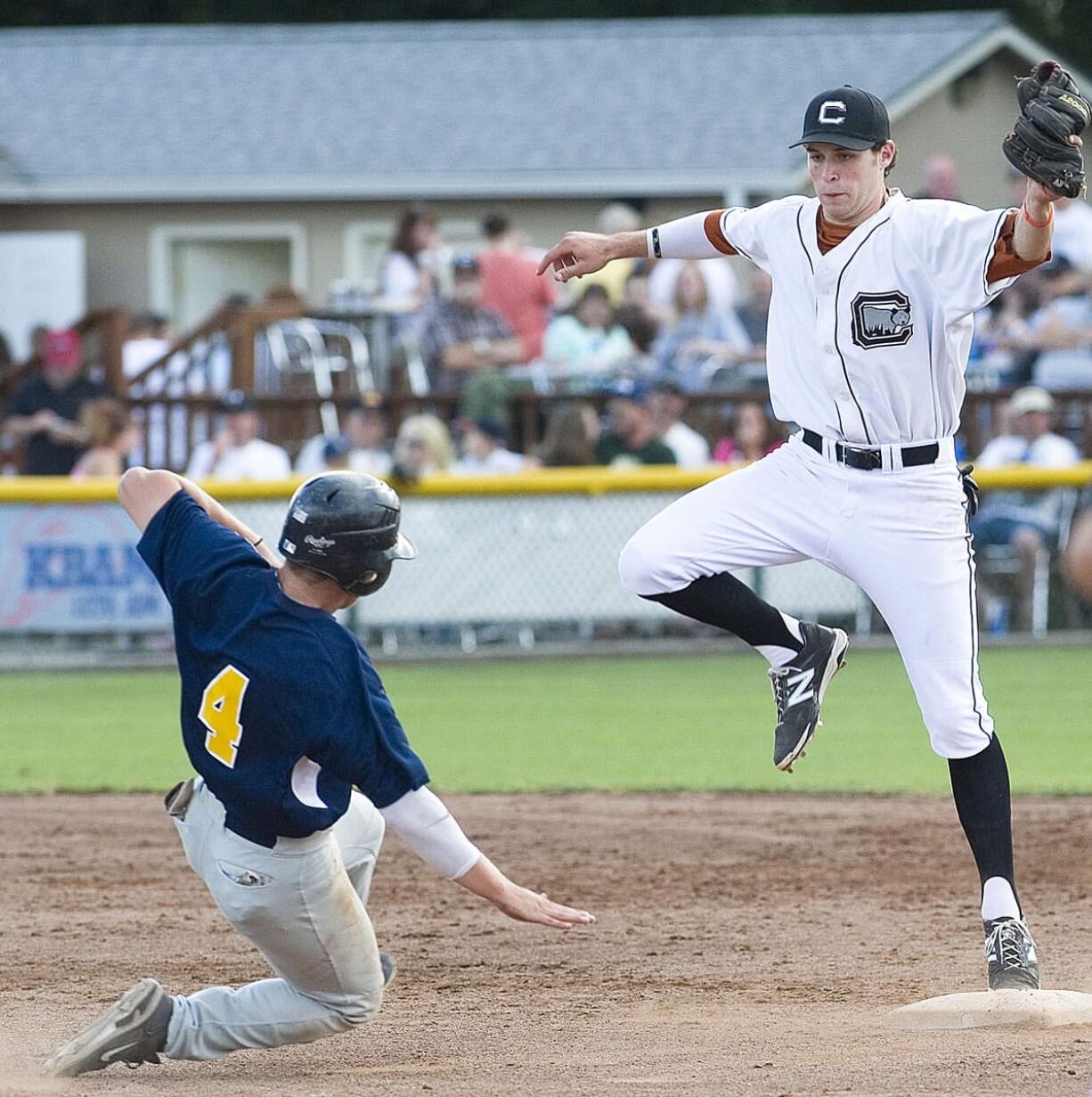 Cowlitz Black Bears shortstop Seaver Whalen, a Union High graduate, gets a foot on the bag in time to retire Kitsap's Jeffery Bohling during a West Coast League game this summer at David Story Field in Longview.