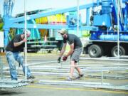 David Fuhr, left, and Thomas Freeman of Stages Northwest erect The Columbian Community Stage for this year's Clark County Fair.