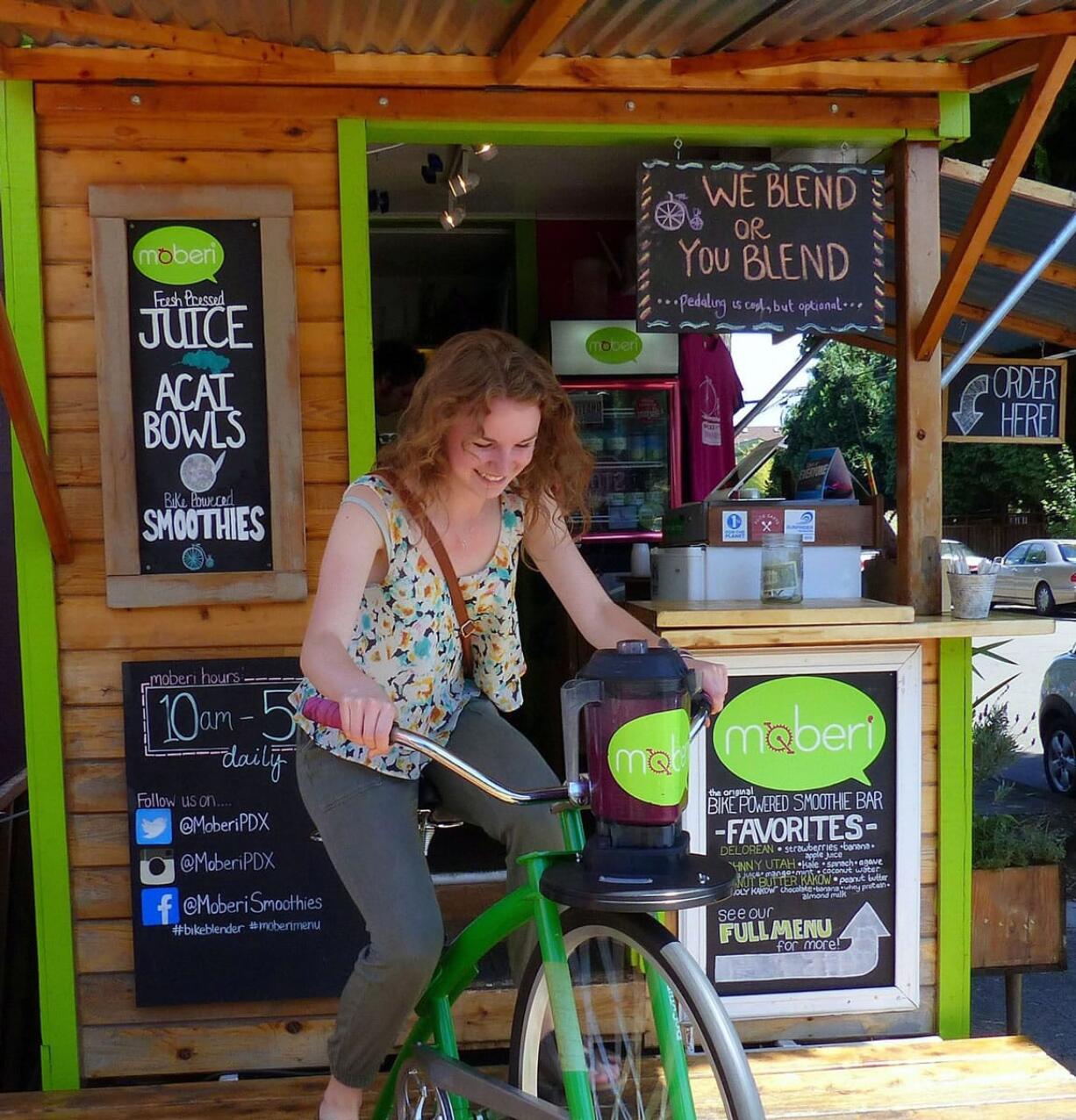 Carly Gray pedals to blend a Mr. Wonderful smoothie at the Moberi smoothie shack on Mississippi Avenue in Portland. &quot;We Blend or You Blend ...