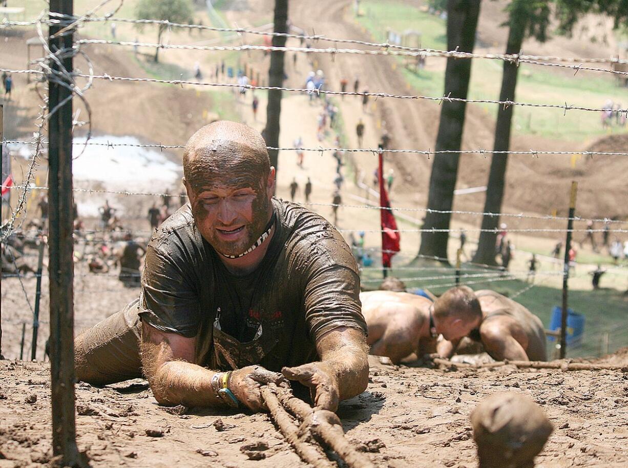 Spartans climb up Horsepower Hill at Washougal Motocross Park like spiders to avoid the strings of barbed wire above.