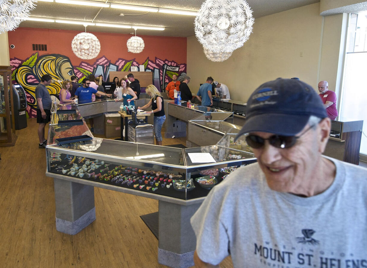 Medical marijuana user Krae Williams, 71, walks out of Main Street Marijuana after buying weed from the shop July 28.