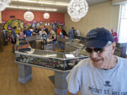 Medical marijuana user Krae Williams, 71, walks out of Main Street Marijuana after buying weed from the shop July 28.