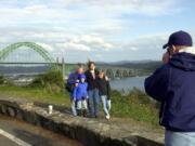 Visitors to Newport, Ore., use the historic Yaquina Bay Bridge as a backdrop for a family portrait.