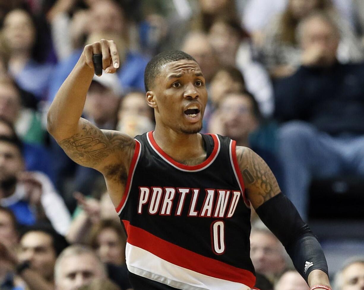 Portland Trail Blazers' Damian Lillard (0) gestures during an NBA basketball game against the Dallas Mavericks Saturday, Feb. 7, 2015, in Dallas.