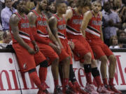 Portland Trail Blazers starters, from left, Wesley Matthews, LaMarcus Aldridge, Damian Lillard, Robin Lopez, and Nicolas Batum, sit on the scorers table during a timeout in the second half of Game 5 of a Western Conference semifinal NBA basketball playoff series against the San Antonio Spurs, Wednesday, May 14, 2014, in San Antonio. San Antonio won 104-82.