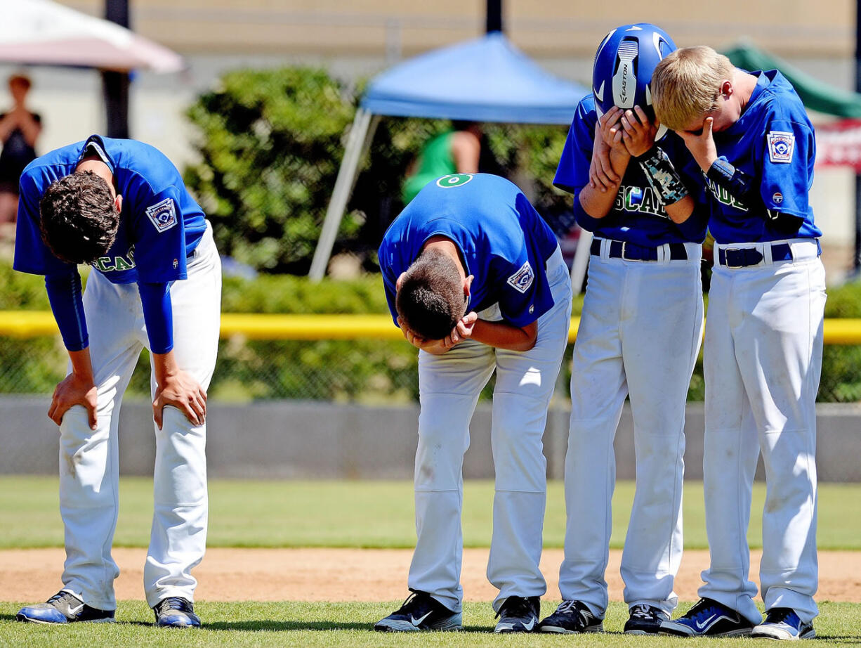 Cascade Little League players Mathew Chudek, Lucas Horowitz, Jake Bowen and Ben Jones show their disappointment after losing to Idaho 8-7 on an a aiding a player call to end the game in the bottom of the 6th inning Friday August 14, 2015 at the Little League Western Regionals in San Bernardino, Calif.