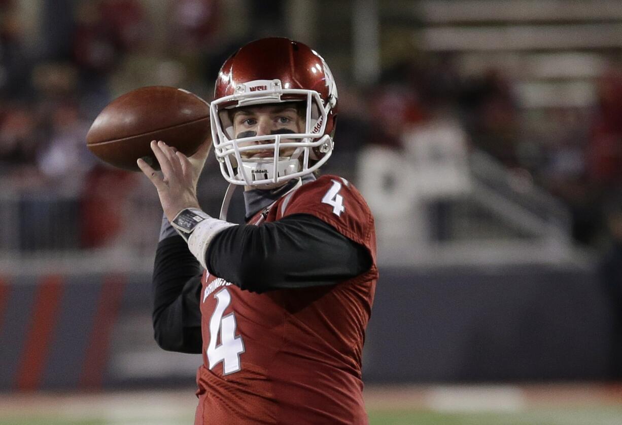 Associated Press files
Luke Falk, above, appears to be claiming quarterback job. Gerard Wicks, right, is WSU's leading returning rusher.