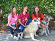 Marianna Benko, from left, Elizabeth Holmes and Coleen Johnston, co-founders of PawLikeMe, a canine matching service, gather with their dogs Aug.