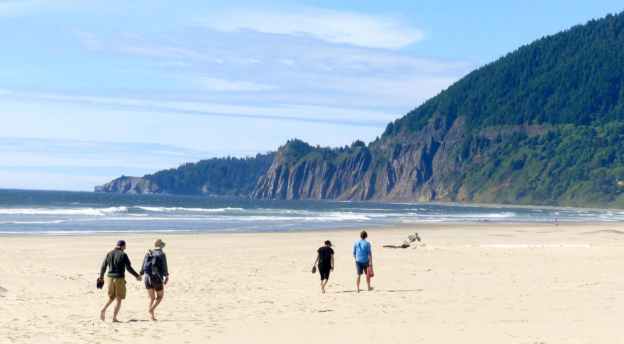 Neahkahnie Mountain rises from the surf as seen from the beach at Nehalem Bay State Park, near Manzanita, Ore.