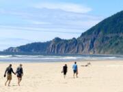 Neahkahnie Mountain rises from the surf as seen from the beach at Nehalem Bay State Park, near Manzanita, Ore.