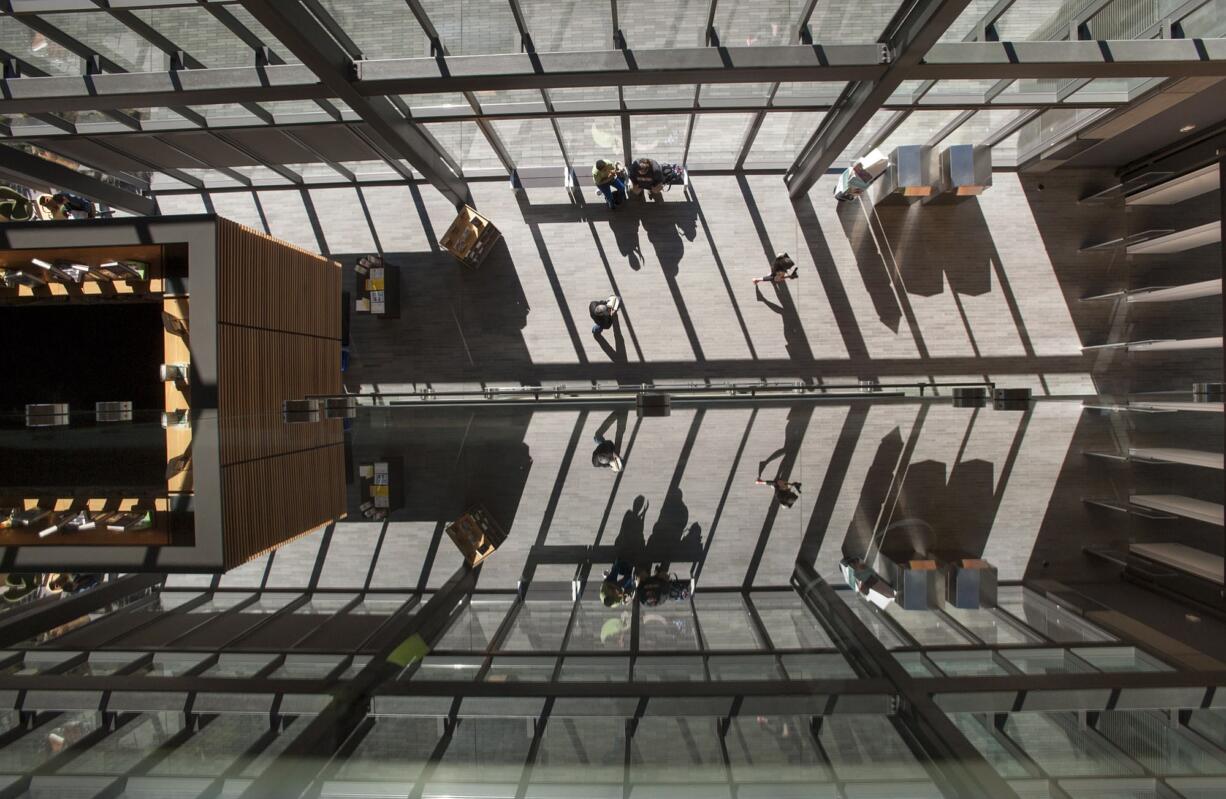 Visitors enjoy the sun-filled atrium of the Vancouver Community Library earlier this year.