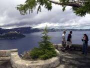 Tourists taking in the view at Crater Lake National Park, Ore.