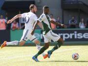 Portland Timbers forward Fanendo Adi (R) shoots during MLS soccer game between Portland Timbers and Vancouver (B.C.) Whitecaps.