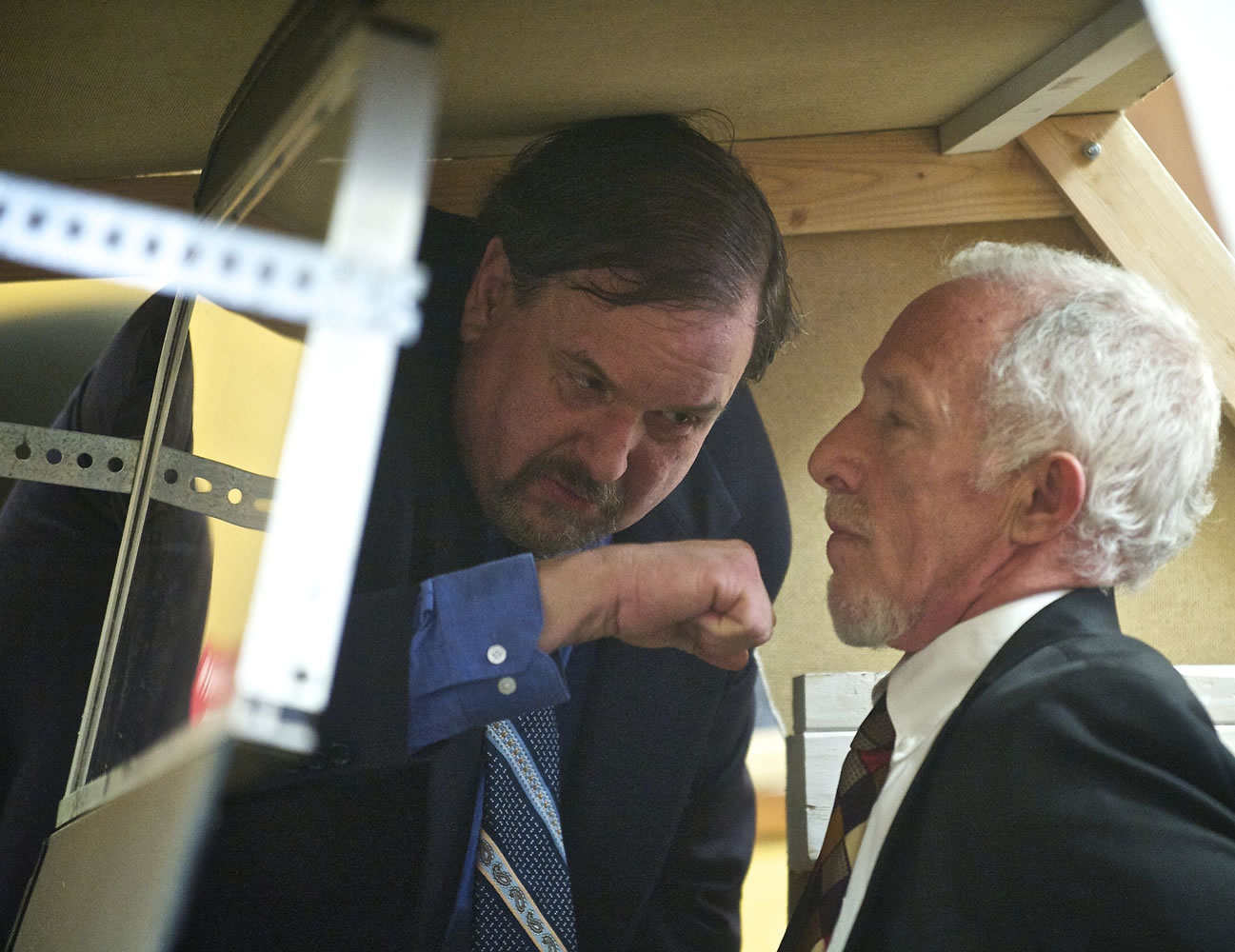 On trial for assault, former Washougal police Officer Robert Ritchie pretends to punch his attorney, Jaime Goldberg, as he sits inside a mock-up of a patrol car while playing the role of victim Tyler Lampman, not pictured, inside Clark County District Court Judge Sonya Langsdorf's courtroom March 14, 2013.