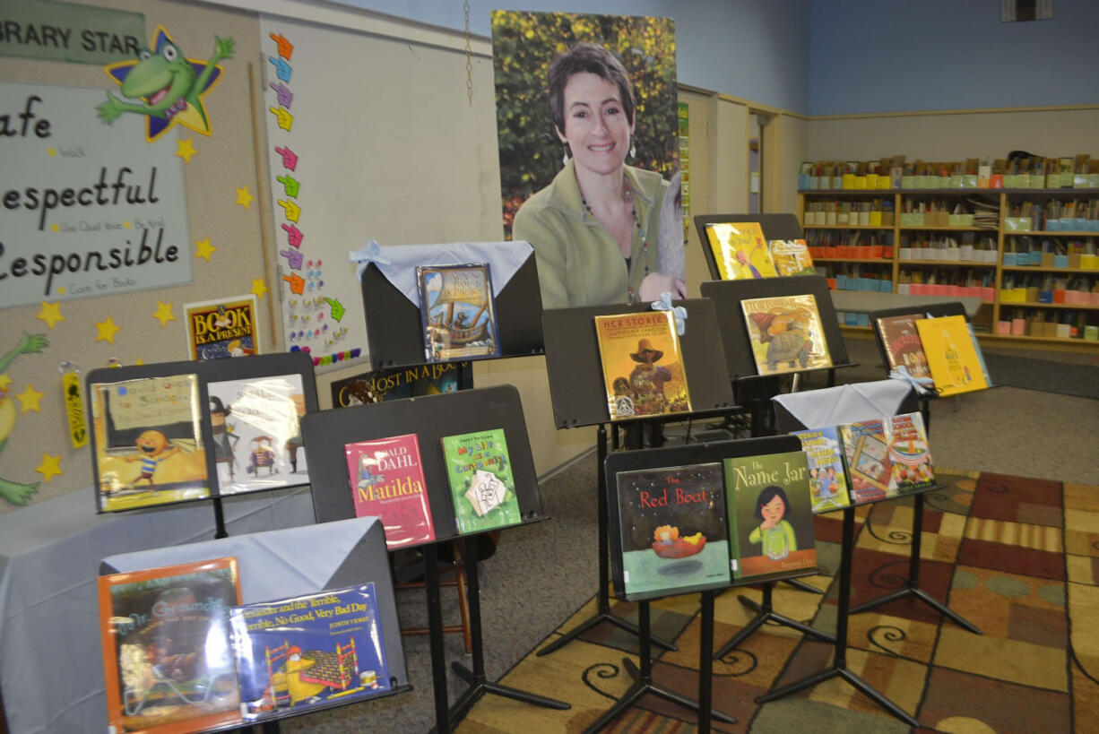 Andrenae Merideth, Michele and Anthony Loveall and Tyler Merideth peruse one of the many new books at the Hathaway Elementary School library.