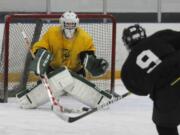 Fort Vancouver Vipers player Eric Bampenchow, right, takes a shot on goalie Brenden Leise during a practice at the Mountain View Ice Arena in Vancouver.