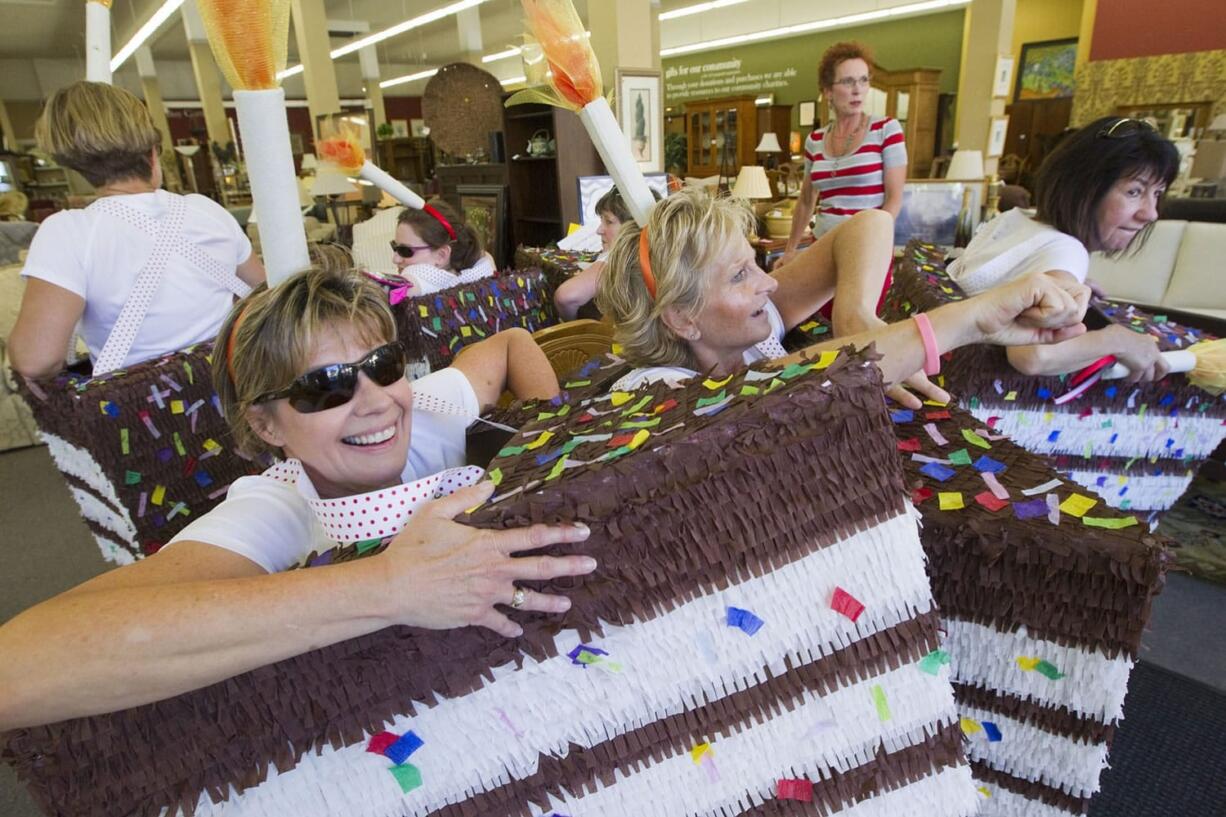 Columbian filesA team called &quot;Its a Cakewalk&quot; play musical chairs at a furniture consignment shop as they participate in the 2014 Summer Solstice Urban Obstacle Race in Vancouver, a charity event to raise money for the Clark County Food Bank.