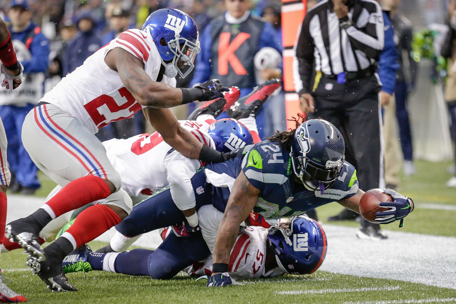 Seattle Seahawks running back Marshawn Lynch (24) dives for yardage on a play against the New York Giants in the second half of an NFL football game, Sunday, Nov. 9, 2014, in Seattle.