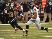 Seattle Seahawks wide receiver Doug Baldwin, right, slips past St. Louis cornerback E.J. Gaines after catching a pass for a 49-yard gain during the first quarter of an NFL football game Sunday, Oct. 19, 2014, in St. Louis. (AP Photo/L.G.