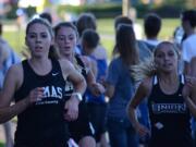 Alissa Pudlitzke, left, of Camas leads a high school cross country race Oct. 7 at Pacific Park in Vancouver.