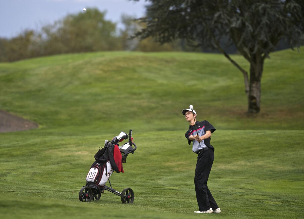 Ben Gruher, of Union, watches his ball head toward the green as he closes out a win on the 18th hole during the 4A district golf tournament at Tri-Mountain Golf Course on Tuesday.