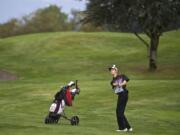 Ben Gruher, of Union, watches his ball head toward the green as he closes out a win on the 18th hole during the 4A district golf tournament at Tri-Mountain Golf Course on Tuesday.