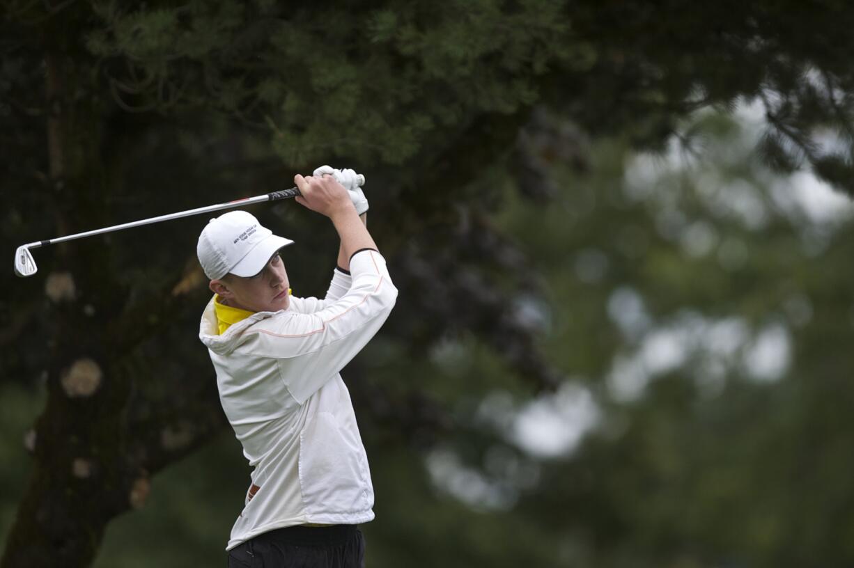 Fort Vancouver's Spencer Tibbits hits off the 17th tee on his way to a 3A win during the district golf tournament at Tri-Mountain Golf Course on Tuesday.