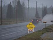 A vehicle drives through high water in Battle Ground last winter.