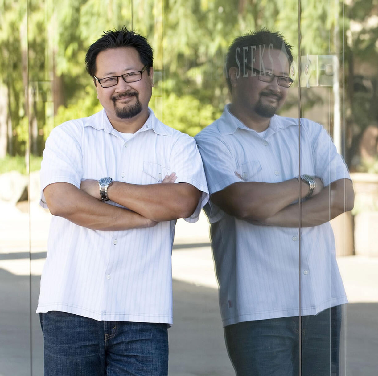 David Mandani is reflected in a glass wall of the Saddleback Church sanctuary in Lake Forest, Calif.