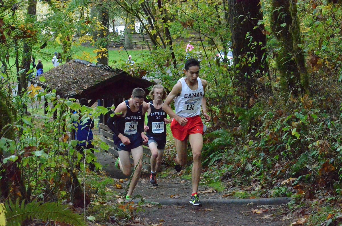 Camas senior Said Guermali, right, leads the 4A district cross country meet Thursday at Lewisville Park.