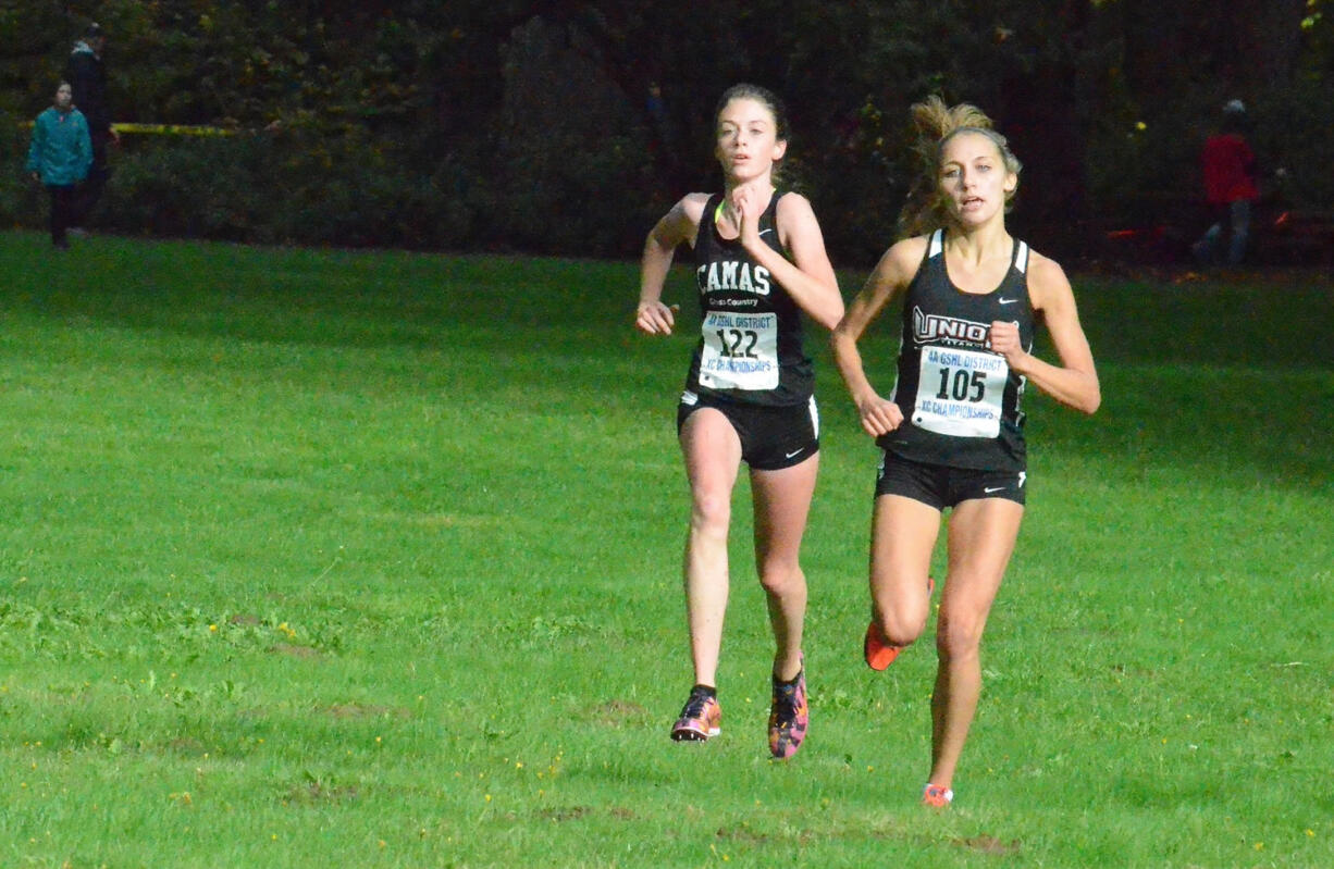 Union senior Alexis Fuller, right, duels with Camas freshman Emma Jenkins during the final stretch of the 4A district cross country meet Thursday at Lewisville Park.