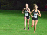 Union senior Alexis Fuller, right, duels with Camas freshman Emma Jenkins during the final stretch of the 4A district cross country meet Thursday at Lewisville Park.