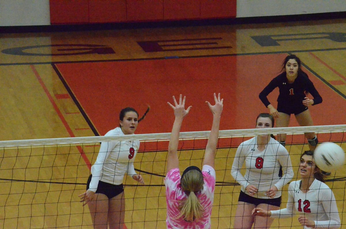 Camas outside hitter Lauren Harris, left, hits a spike in a volleyball match against Battle Ground on Thursday.