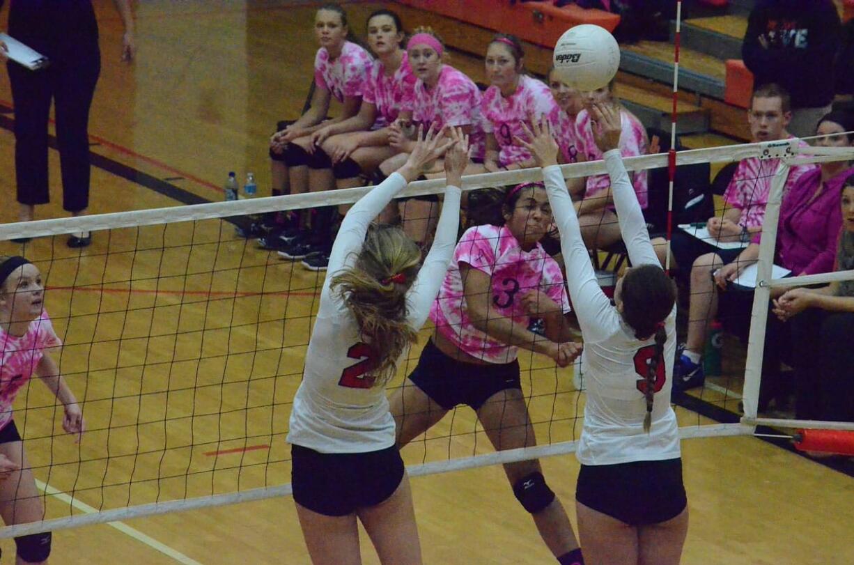 Battle Ground's Brooke Van Sickle (3) hits a spike as Anna Roche (2) and Lauren Harris (9) of Camas attempt to block Thursday in Battle Ground.