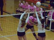 Battle Ground's Brooke Van Sickle (3) hits a spike as Anna Roche (2) and Lauren Harris (9) of Camas attempt to block Thursday in Battle Ground.