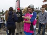 Mountain View High School students Daisy Garcia and Mark Hall hug as the two mourn their friends, who died Friday night in a car crash at the corner of Northeast 136th Avenue and Fourth Street.