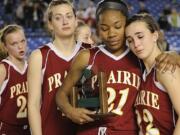 Lanae Adams, 21, of Prairie High School consoles Lauren Goecke, 22, right, after receiving the second place trophy after losing to Holy Names High School at the 2011 Hardwood Classic 3A girls State Basketball Championships at the Tacoma Dome in Tacoma, Washington. Holy Names beat Prairie 57-48. Andrea Smith, 42, and Nicole Goecke, 23, are at left.