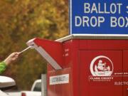 A voter uses a drive-up collection box to cast a ballot on Nov.