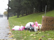 A roadside memorial along Northeast 112th Avenue in east Vancouver is seen on Sunday in the spot where four trick-or-treaters were struck by a car Friday evening.