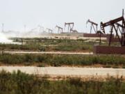 A line of oil pumps on land owned by Fasken Oil and Ranch near Midland, Texas, in late July.