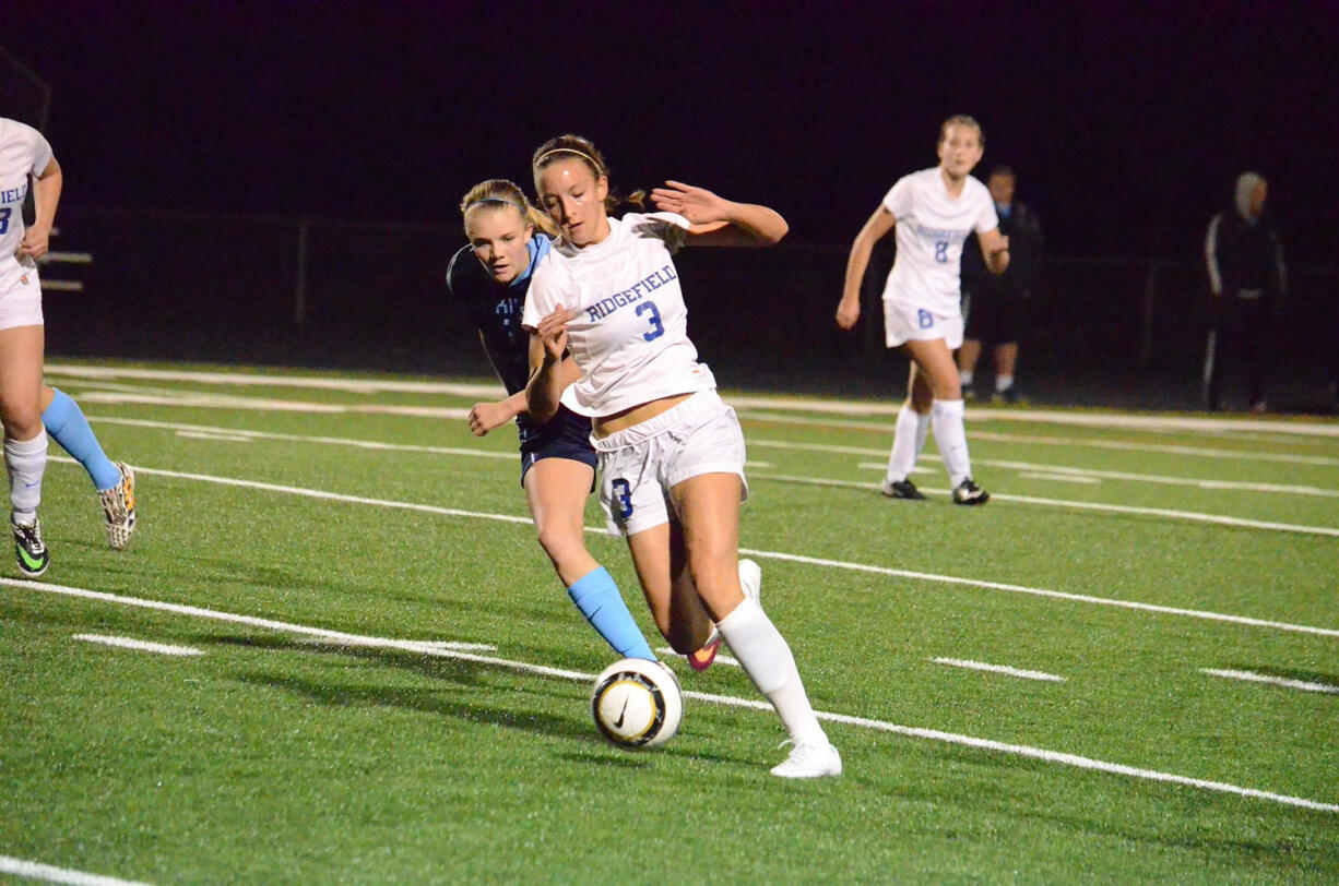 Ridgefield's Taryn Ries (3) is chased by Hockinson's Sophia Niehaus during the 2A District 4 championship soccer match Thursday at Ridgefield High School.