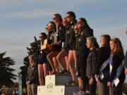 The Camas girls cross country team atop the podium after winning the Class 4A state championship Saturday.