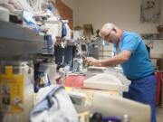 George Pobi, lead clinical engineering technician, works on a monitor Tuesday afternoon in his shop in the basement at Legacy Salmon Creek Medical Center.