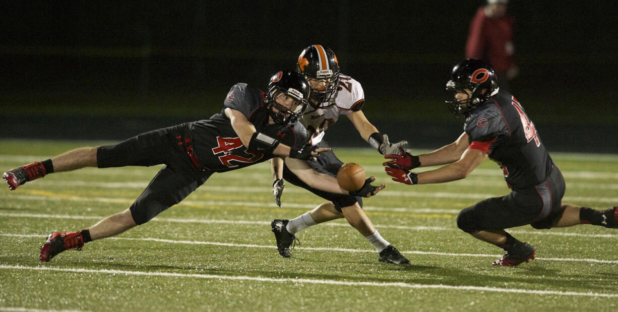 Camas defender Gabe Lopes, left, was one of three local high school football players named first-team all-state.