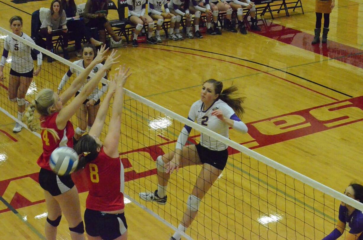 Columbia River's Brooke Williams (2) slams an attack past a Kamiakan block attempt.