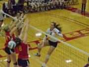 Columbia River's Brooke Williams (2) slams an attack past a Kamiakan block attempt.