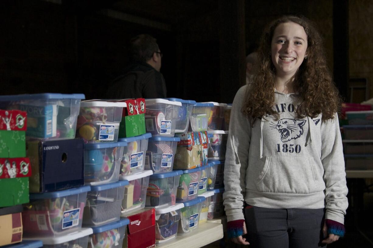 Sierra Swearingen, 15, of Battle Ground stands amid some of the 300 shoeboxes full of gifts that she collected for Operation Christmas Child.